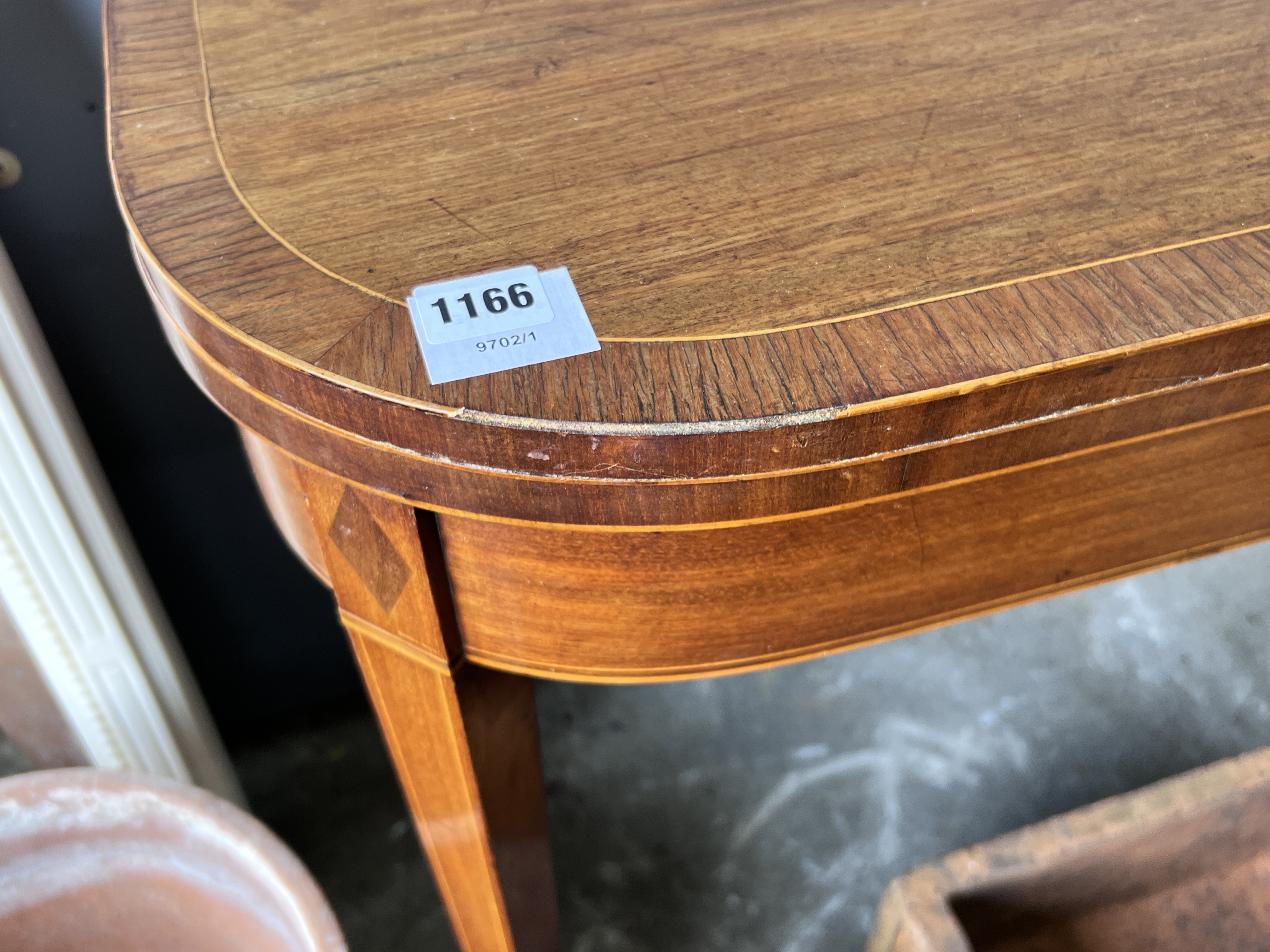 A George III rosewood banded inlaid mahogany tea table, width 92cm, depth 45cm, height 74cm (one leg in need of restoration)